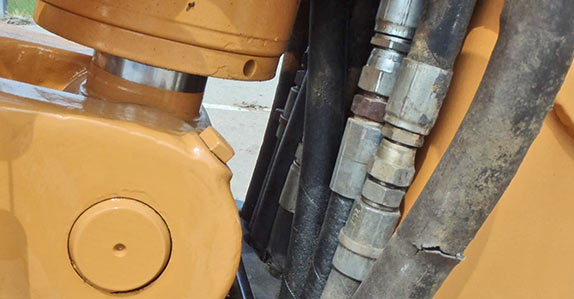 Check for signs of leaks around hoses and other hydraulic system components
