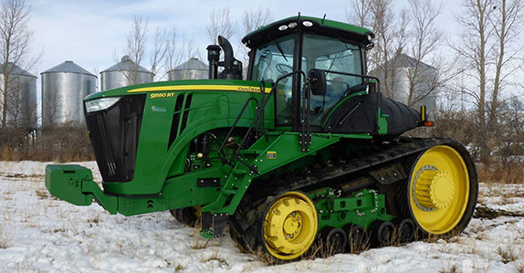 John Deere 9560RT track tractor sold at a Ritchie Bros. farm equipment auction.